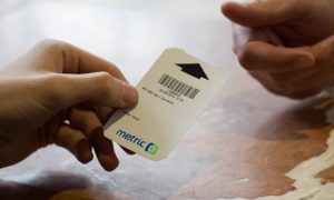 Parking ticket being handed to pay at manual cashier